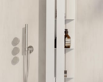 May include: A vertical white wall-mounted shower shelf unit with multiple open storage compartments, featuring a sleek design. Beside it, a brushed metal shower fixture with three circular control knobs and a handheld shower head on a hose.