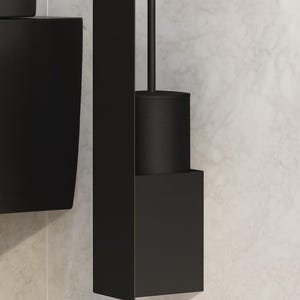 May include: A matte black wall-mounted toilet brush holder featuring a vertical rectangular backplate and a cylindrical brush canister. The design includes a slender handle extending from the center of the canister, finished in a solid dark tone.