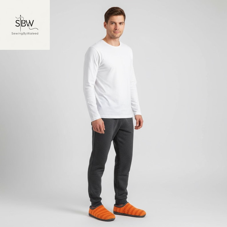 May include: A person wearing a white long-sleeve shirt, dark gray sweatpants, and orange striped slippers. The slippers have a soft, textured appearance. The image is set against a plain white background.