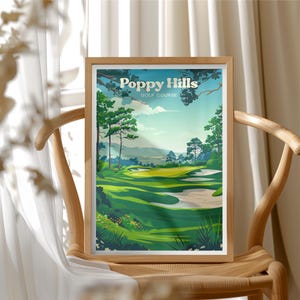May include: A framed print of Poppy Hills Golf Course. The artwork depicts a vibrant golf course scene with lush green fairways, sand traps, and trees under a blue sky. The words "Poppy Hills Golf Course" are at the top of the print.