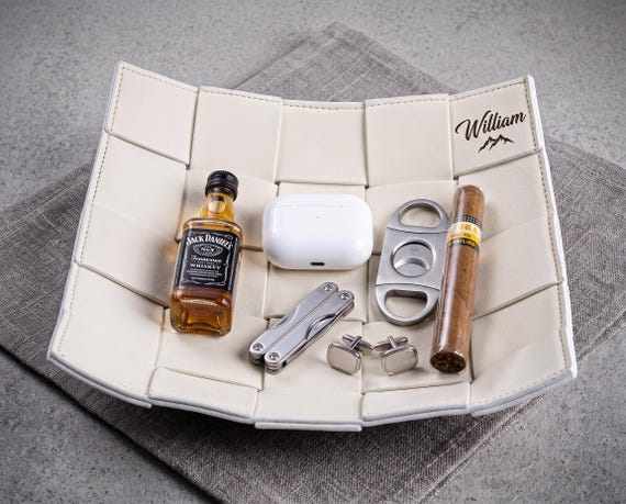 Hand-woven leather valet tray with custom engraving — the kind of desk/dresser piece that looks like it belongs in a high-end men's boutique, not an Amazon warehouse.