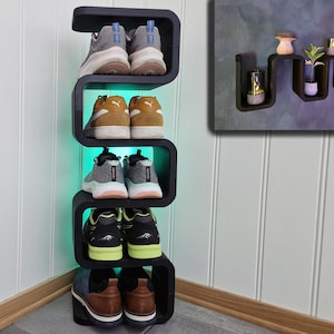 May include: A white ceramic mug with a black handle and the text "But First, Coffee" in a bold, black font. The mug is set against a neutral background, highlighting its simple design.