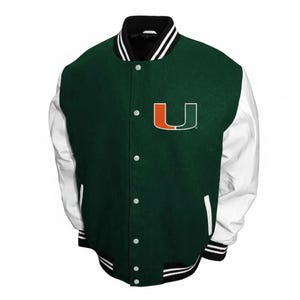 May include: A green and white varsity jacket with a black collar and cuffs. The jacket has white sleeves, a button-up front, and the letter "U" in orange and green on the chest.
