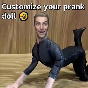 May include: A prank doll with a man's face and a black body suit. The image has the text "Customize your prank doll" at the top. The doll is in a crawling position on a wooden surface.