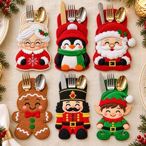 May include: Six fabric cutlery holders shaped like Christmas characters including Mrs. Claus, a penguin, Santa Claus, a gingerbread person, a nutcracker, and an elf. Each holder contains a silver fork, a silver spoon, and a silver knife.