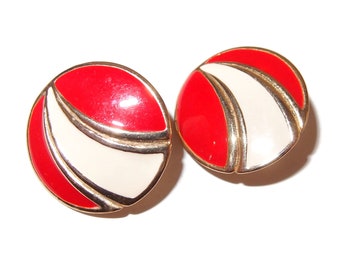 May include: Pair of round earrings with a red and white design. The earrings have a gold-colored trim and a glossy finish. The earrings are set against a white background.
