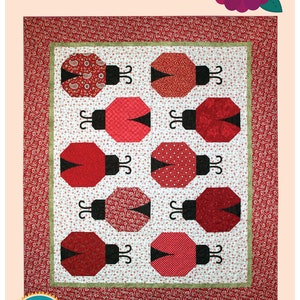 May include: A quilt pattern featuring a design of nine red ladybugs with black spots and antennae. The quilt pattern is called "Lily's Ladybugs" and is layer cake friendly.