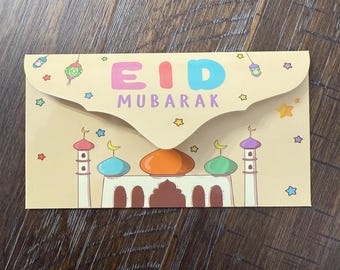 May include: A tan Eid Mubarak greeting card with a mosque illustration. The card features colorful text and decorative elements like stars and lanterns. The mosque has domes in orange, blue, and green.