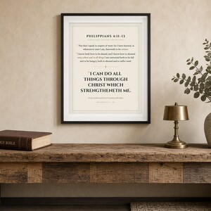May include: A framed wall art print featuring the Bible verse Philippians 4:11-13 with the text I CAN DO ALL THINGS THROUGH CHRIST WHICH STRENGTHENETH ME in black lettering on a cream background, displayed in a simple black frame.