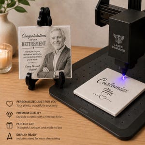 May include: A white ceramic tile featuring a laser-engraved portrait of a man and the text Congratulations on your RETIREMENT. A second tile on a black laser engraver platform displays the text Customize Me with a heart icon below it.