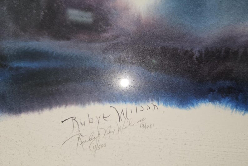 May include: Watercolor painting depicting a night scene with a bright moon. The artwork features shades of blue, purple, and white, with the artist's signature and the text "Ruby Wilson" and "11/500" visible.