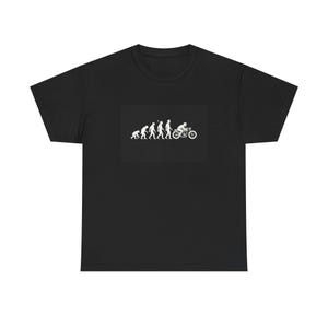 May include: Black t-shirt featuring a white graphic of the evolution of man, culminating in a person riding a motorcycle. The design shows the progression from ape to biker. A simple, yet bold design for motorcycle enthusiasts.