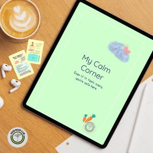May include: A tablet screen shows "My Calm Corner" with a cloud illustration and the text "Even if it feels scary, you're safe here." Beside it are flashcards, a coffee, earbuds, and a "Good Mood Club" sticker on a wooden surface.