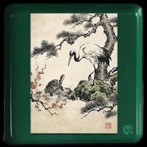 May include: A square dark green tray featuring a central rectangular print of a crane and a turtle beneath a pine tree with plum blossoms. The artwork includes a red square seal in the bottom right corner and a small green circular logo on the tray.