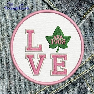 May include: Embroidered patch with a pink border and the word "LOVE" in pink letters. A green ivy leaf with "AKA 1908" is on the right. The patch is on a denim background.