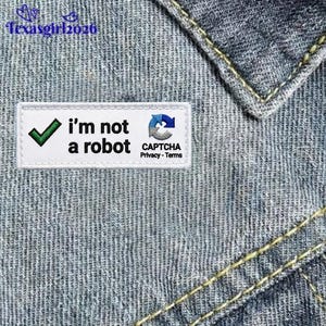 May include: A white rectangular patch with the text "I'm not a robot" and a green checkmark. The patch also includes the CAPTCHA logo and the text "CAPTCHA Privacy - Terms". The patch is on a denim background.