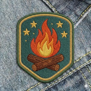 May include: Embroidered patch featuring a campfire design. The patch has a teal background with a gold border. The campfire is depicted with orange and yellow flames above two brown logs, and four gold stars.
