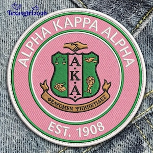 May include: Embroidered patch featuring the words "ALPHA KAPPA ALPHA" in white on a pink background. The patch includes a green and gold crest with the letters "AKA" and the text "EST. 1908". The patch is round and has a green border.