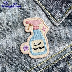 May include: A white ceramic mug with a black handle and the text "But First, Coffee" in a bold, black font. The mug is sitting on a wooden surface. The mug is 4 inches tall.