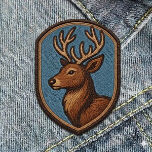 May include: A white ceramic mug with a black handle and the text "But First, Coffee" in a bold, black font. The mug is set against a blurred background, suggesting a cozy setting. The mug appears to be approximately 4 inches tall.