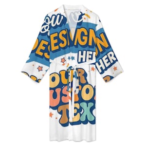 May include: White robe with a colorful design featuring the words "DESIGN HER" and "OUR CUSTOM TEXT" in orange, blue, and teal. The robe has a tie closure and star accents.