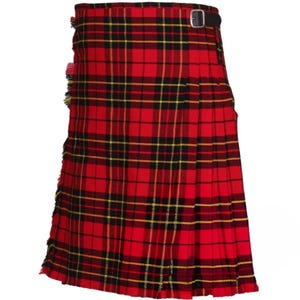 May include: A red kilt featuring a black and yellow plaid pattern with vertical pleats along the side and a black leather strap with a silver-toned metal buckle at the waist. The fabric has a visible fringe detail along the left side edge.