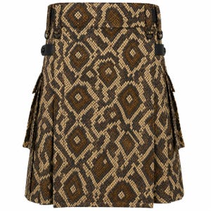 May include: A kilt featuring a brown and tan snakeskin-inspired diamond pattern. The garment includes black side straps with metal buckles, belt loops at the waistband, and two large cargo-style pockets on the sides with pleated fabric details.