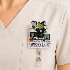 May include: A badge reel featuring a green frog wearing a witch hat and a black shirt labeled X-RAY TECH. The frog holds an X-ray image, with a pumpkin, a computer monitor showing a hand X-ray, and text reading We see what others can't SPOOKY SHIFT.