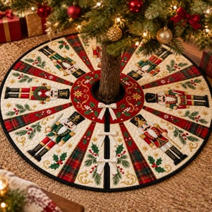 May include: A round quilted Christmas tree skirt featuring a repeating pattern of nutcracker figures, red and green plaid sections, and holly berry motifs. The center is a deep red circle with gold scrollwork and three white ribbon ties.