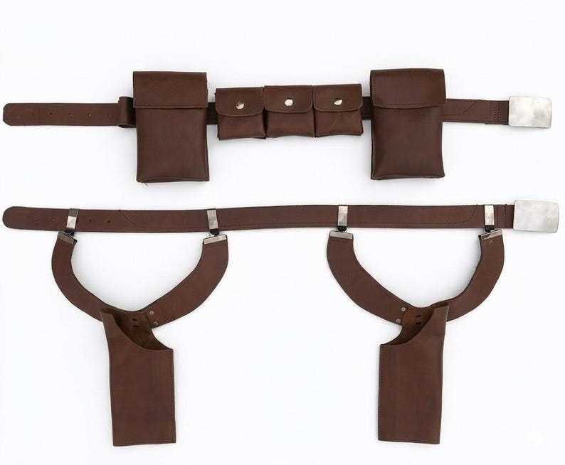 May include: Brown leather utility belt with multiple pouches and a silver-colored buckle. The belt features two large pouches, three smaller pouches, and two holster-style attachments. The belt is designed for carrying items.
