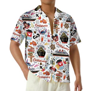 May include: White short-sleeved button-down shirt with a colorful pattern featuring cruise ships, cartoon characters, and nautical elements. The shirt has a relaxed fit and a classic collar.