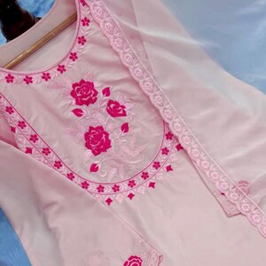 May include: A light pink embroidered tunic and matching sheer scarf. The tunic features a floral design in a darker pink shade around the neckline and sleeves. The brand name "ZiyaFab" is visible in the top right corner.