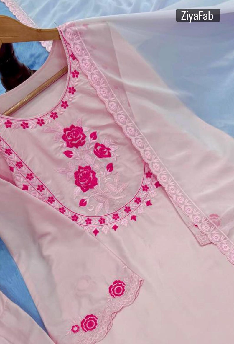 May include: A light pink embroidered tunic and matching sheer scarf. The tunic features a floral design in a darker pink shade around the neckline and sleeves. The brand name "ZiyaFab" is visible in the top right corner.