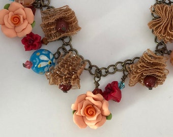 Handmade Beaded Bracelet with Peach Roses, Millefiori Glass Beads and Gold Lacey Ruffle Charms.  Large Heart Closure.