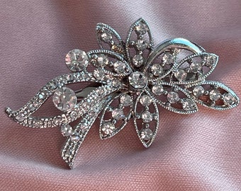 Vintage floral brooch with clear rhinestones.  Bouquet crystal brooch on silver tone metal.