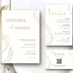 Puede incluir: Un conjunto de papelería de boda con un diseño minimalista. La invitación presenta los nombres "Victoria y Daniel" y la fecha "16.08.2026". El conjunto incluye una tarjeta de detalles y una tarjeta RSVP, todo en una paleta de colores suaves y neutros con elegantes ilustraciones en forma de hojas.