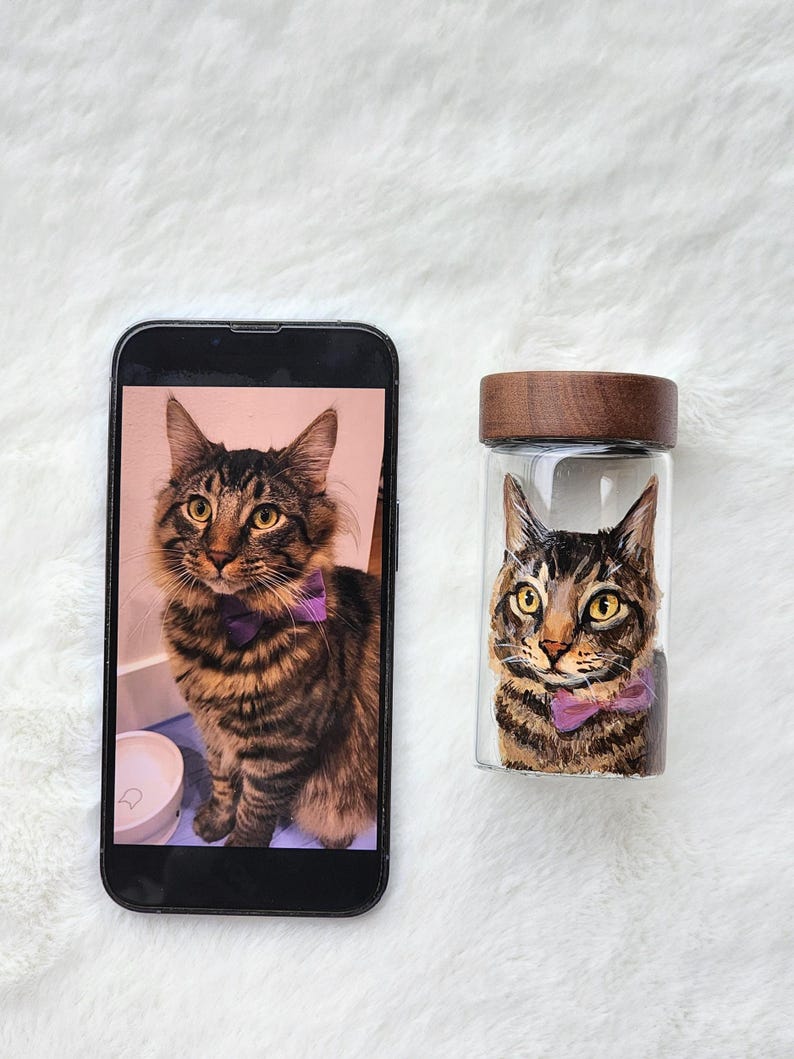 Hand-painted pet memorial jar with realistic portrait on UV-resistant glass, featuring an airtight seal for storing fur or ashes.