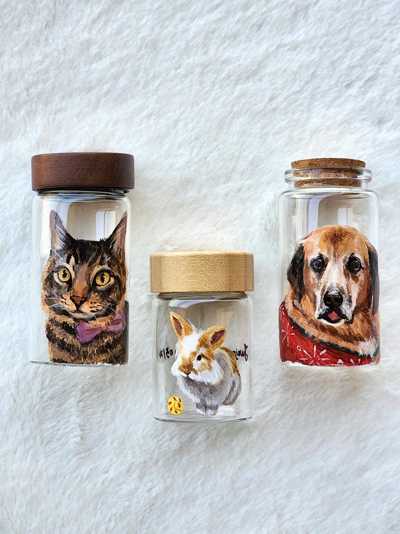 Hand-painted pet memorial jar with realistic portrait on UV-resistant glass, featuring an airtight seal for storing fur or ashes.