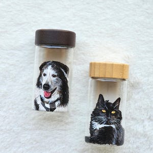 Hand-painted pet memorial jar with realistic portrait on UV-resistant glass, featuring an airtight seal for storing fur or ashes.