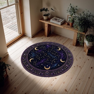 Pode incluir: Tapete redondo com um design celestial. O tapete apresenta um fundo azul escuro e roxo com constelações, luas crescentes douradas e uma borda decorativa. Está colocado sobre um chão de madeira.