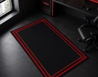 May include: A rectangular floor mat featuring a solid black center and a vibrant red glowing border with geometric corner accents. The mat has a smooth, dark surface texture and is positioned on a floor in a room with dark furniture.