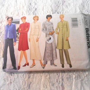 May include: A Butterick classics sewing pattern packet featuring illustrations of women's clothing designs. The designs include a blue jacket and pants, a red dress, a cream-colored suit, a gray outfit, and a long green coat with pants. The packet has the number 6269.