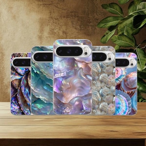 May include: Five phone cases with iridescent shell designs. The cases feature a variety of colors, including blue, purple, and brown, with a glossy finish. The cases are displayed on a wooden surface.