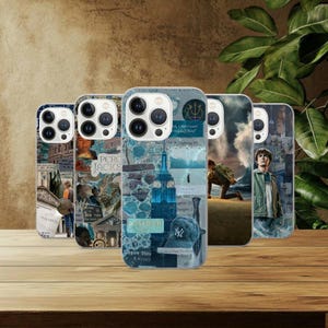 May include: Five phone cases with different designs. The cases have collages with images of the Empire State Building, text, and other graphics. The colour scheme includes shades of blue, white, and beige, with a wooden surface in the background.