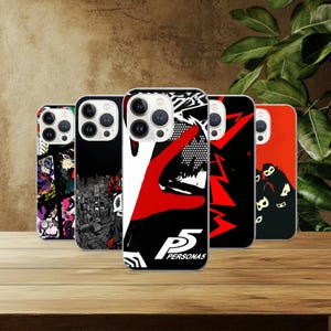 May include: Five phone cases with distinctive graphic designs. The cases display a range of colours, including black, red, white, and purple. The designs feature cityscapes, abstract art, and the text "PERSONA5".