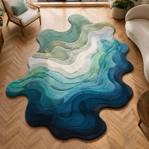 May include: A large, abstract rug with a flowing, organic shape. The rug features a gradient of colors, transitioning from deep blues to lighter greens and whites. The design resembles water or a landscape, adding a modern touch to the room.