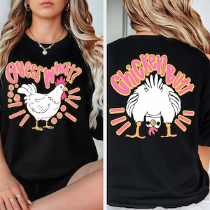 May include: Black sweatshirt with a white chicken graphic and the text "Guess What?" on the front. The back of the sweatshirt features a chicken graphic and the text "Chicken Butt". The graphics are outlined in pink and yellow.
