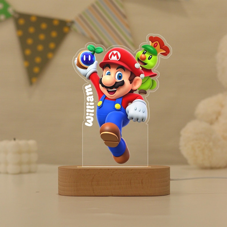 May include: A custom acrylic night light featuring a colourful graphic of Mario holding a blue orb with a green sprout, accompanied by a green character with a red crown. The name William is printed vertically in white text on the clear acrylic panel.
