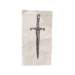 May include: A black and white illustration of a dagger on a beige linen fabric background.