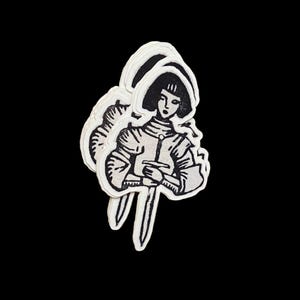 May include: A stack of three stickers featuring a black and white illustration of a person in armor holding a sword. The person has short hair and is facing forward. The stickers have a white border and are set against a black background.